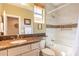 Bright bathroom with granite counters, dual sinks, tub and shower combo at 650 E Myrtle Pass, Queen Creek, AZ 85140