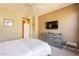 Bedroom with neutral tones, carpet, ceiling fan, and TV on the dresser at 650 E Myrtle Pass, Queen Creek, AZ 85140