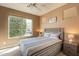 Comfortable bedroom with a ceiling fan, window, and neutral decor at 650 E Myrtle Pass, Queen Creek, AZ 85140