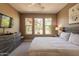 Bedroom with carpet, a ceiling fan, TV on the dresser, and a large window view at 650 E Myrtle Pass, Queen Creek, AZ 85140