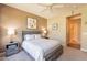 Bedroom with neutral tones, carpet, ceiling fan, and view to the hallway at 650 E Myrtle Pass, Queen Creek, AZ 85140