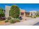 Charming home featuring a front yard, arched entry, desert landscaping, and a multi-car garage at 650 E Myrtle Pass, Queen Creek, AZ 85140