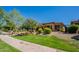 Charming home featuring a well-manicured lawn, colorful shrubbery, and an inviting front patio, all under a clear blue sky at 650 E Myrtle Pass, Queen Creek, AZ 85140