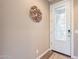 A welcoming foyer features a decorative wall art, a front door with glass, and tiled flooring at 650 E Myrtle Pass, Queen Creek, AZ 85140