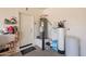 Garage interior with water softener and supplies, access door to exterior at 650 E Myrtle Pass, Queen Creek, AZ 85140