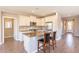 A kitchen with a bar, stainless steel appliances, stone countertops, and views of the dining area at 650 E Myrtle Pass, Queen Creek, AZ 85140