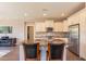 A kitchen with granite countertops and an island with barstool seating is featured in the photo at 650 E Myrtle Pass, Queen Creek, AZ 85140