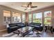 The stylish living room is bathed in natural light and features contemporary furnishings and a ceiling fan at 650 E Myrtle Pass, Queen Creek, AZ 85140