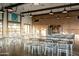 Bright meeting room with exposed brick walls, white tables and chairs, and natural light at 650 E Myrtle Pass, Queen Creek, AZ 85140