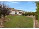 Expansive backyard featuring a well-manicured lawn and landscaped garden beds at 6694 S Banning St, Gilbert, AZ 85298