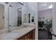 Bathroom featuring double sinks, a dark wood vanity, and warm neutral paint at 6694 S Banning St, Gilbert, AZ 85298