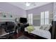 Bedroom featuring cool-toned paint, dark wood floors, and plantation shutters at 6694 S Banning St, Gilbert, AZ 85298