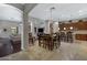 This open concept dining room displays travertine floors and an elegant light fixture at 6694 S Banning St, Gilbert, AZ 85298