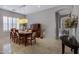 Dining room with a wooden table, tiled floors, and contemporary lighting at 6694 S Banning St, Gilbert, AZ 85298