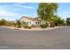 Corner lot home displaying attractive desert landscaping, a tile roof, and neutral colored stucco at 6694 S Banning St, Gilbert, AZ 85298