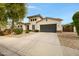 Charming two-story home with a spacious driveway, a neutral color palette, and beautiful curb appeal at 6694 S Banning St, Gilbert, AZ 85298