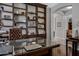 Home office with built-in shelves, a large desk, and hardwood floors at 6694 S Banning St, Gilbert, AZ 85298