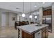 Gourmet kitchen features stainless steel appliances, a white quartz island, and dark wood cabinets at 6694 S Banning St, Gilbert, AZ 85298
