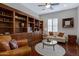 Living room showcasing custom built-in shelving and comfortable seating around a round glass table at 6694 S Banning St, Gilbert, AZ 85298