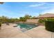 Serene backyard pool area with meticulously manicured landscaping and a tranquil view at 6694 S Banning St, Gilbert, AZ 85298