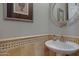 Close up of a powder room sink featuring a decorative mirror and neutral paint at 6694 S Banning St, Gilbert, AZ 85298