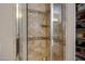Walk-in shower tiled with decorative accent and a clear glass shower door at 6694 S Banning St, Gilbert, AZ 85298