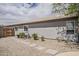 Exterior view of the home's gray facade with tile roof and xeriscaped backyard at 720 W Gail Ct, Gilbert, AZ 85233