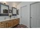 A well-lit bathroom with double vanity, warm cabinets, and tiled floor at 720 W Gail Ct, Gilbert, AZ 85233