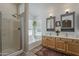 Bright bathroom featuring a shower, soaking tub, double sinks, and well-lit mirrors at 720 W Gail Ct, Gilbert, AZ 85233