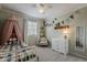 Cozy bedroom features a window, a shelf with decorations, and a white dresser at 720 W Gail Ct, Gilbert, AZ 85233