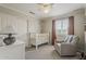 A neutral Bedroom with a crib, chair, and large dresser at 720 W Gail Ct, Gilbert, AZ 85233