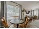 Charming dining area with wood table, overlooking a large window with lots of natural light and backyard views at 720 W Gail Ct, Gilbert, AZ 85233