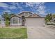 Charming single-story home with manicured lawn and a two-car garage at 720 W Gail Ct, Gilbert, AZ 85233