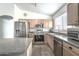 A bright kitchen with stainless steel appliances, granite countertops, and ample cabinet space at 720 W Gail Ct, Gilbert, AZ 85233