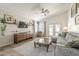 Comfortable living room with vaulted ceiling, ceiling fan, and backyard access at 720 W Gail Ct, Gilbert, AZ 85233