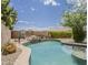 Backyard pool with rock waterfall feature and basketball hoop at 720 W Gail Ct, Gilbert, AZ 85233