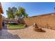 Private backyard with a trampoline, green turf, brick fire pit and patio, perfect for outdoor enjoyment at 7424 W Pioneer St, Phoenix, AZ 85043