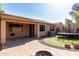 Spacious backyard featuring artificial grass, a trampoline, and a cozy patio area at 7424 W Pioneer St, Phoenix, AZ 85043