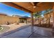 Covered outdoor living space with a fire pit, built-in kitchen, and gazebo in a backyard at 7424 W Pioneer St, Phoenix, AZ 85043