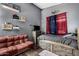 The bedroom features a wooden bed, shelving, and a cozy seating area at 7424 W Pioneer St, Phoenix, AZ 85043