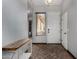 Inviting entryway featuring neutral tile flooring and a convenient bench for seating and storage at 7424 W Pioneer St, Phoenix, AZ 85043
