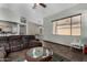 Spacious living room with tile flooring, ceiling fan, large windows, and neutral color palette at 7424 W Pioneer St, Phoenix, AZ 85043