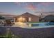 Enjoy this backyard oasis with a covered patio, lounge chairs, a sparkling pool, and tranquil landscaping at 766 E Taylor Trl, San Tan Valley, AZ 85143