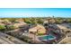 Aerial view of a backyard featuring a pool, covered patio, and well-maintained landscaping at 766 E Taylor Trl, San Tan Valley, AZ 85143
