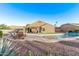 Backyard with a pool and patio seating area with an outdoor grill at 766 E Taylor Trl, San Tan Valley, AZ 85143