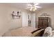 Comfortable bedroom with a ceiling fan, double door entry and traditional furnishings at 766 E Taylor Trl, San Tan Valley, AZ 85143