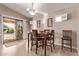 Cozy dining area with tile floors, neutral walls, and a sliding glass door to an outdoor living space at 766 E Taylor Trl, San Tan Valley, AZ 85143