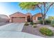Charming single-story home boasts a well-manicured front yard with desert landscaping and a two-car garage at 766 E Taylor Trl, San Tan Valley, AZ 85143