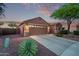 Single-story house featuring a two-car garage, stone accents, and desert landscaping at 766 E Taylor Trl, San Tan Valley, AZ 85143