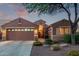 Charming single-story home with a well-manicured front yard and a two-car garage at dusk at 766 E Taylor Trl, San Tan Valley, AZ 85143